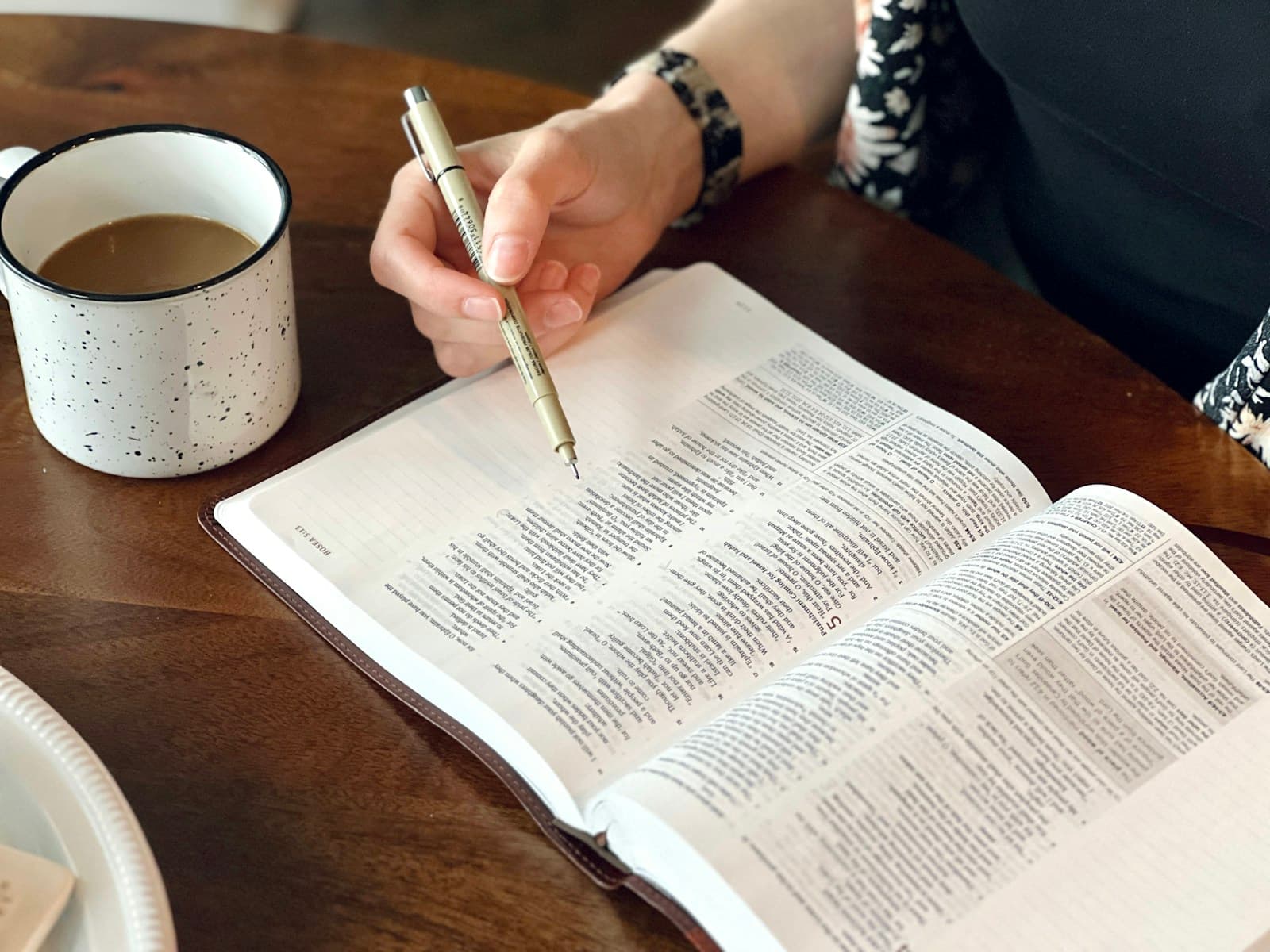 A reader making notes beside a Bible passage